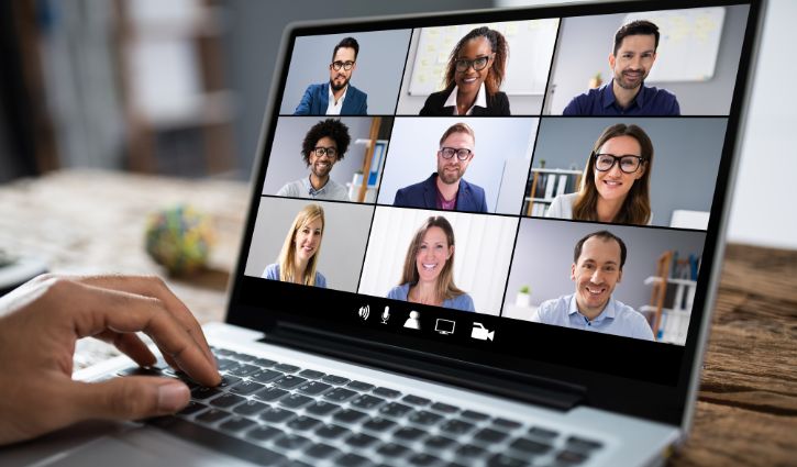 Man Working From Home Having Online Group Videoconference On Laptop