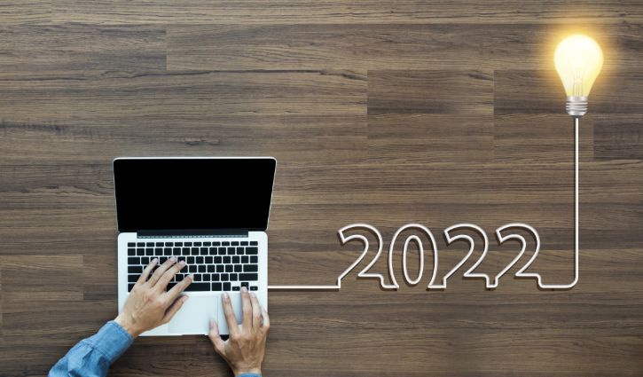 Creative light bulb idea 2022 new year, With businessman working on laptop computer PC, Top view from above