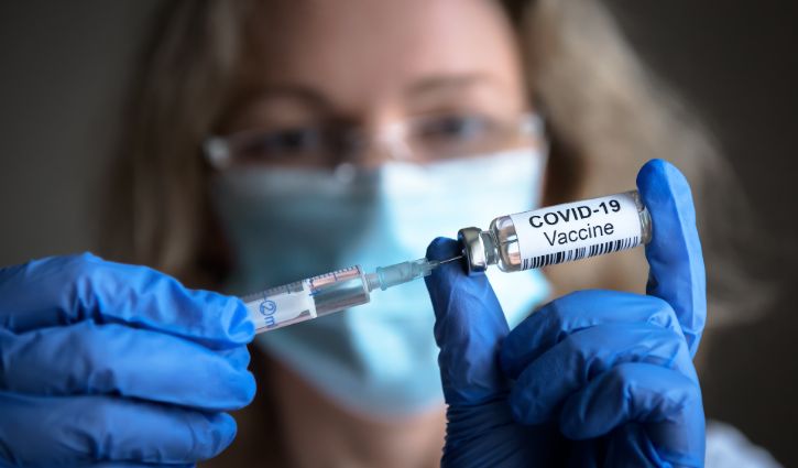 COVID vaccine, nurse with needle